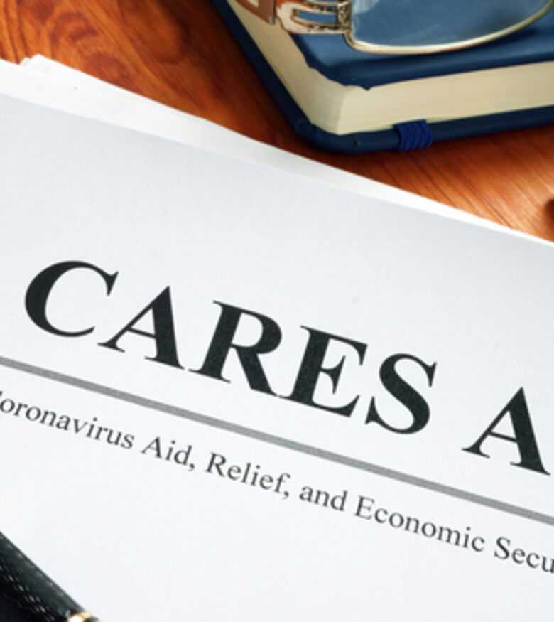 CARES Act document with pen and notepad for financial assistance information