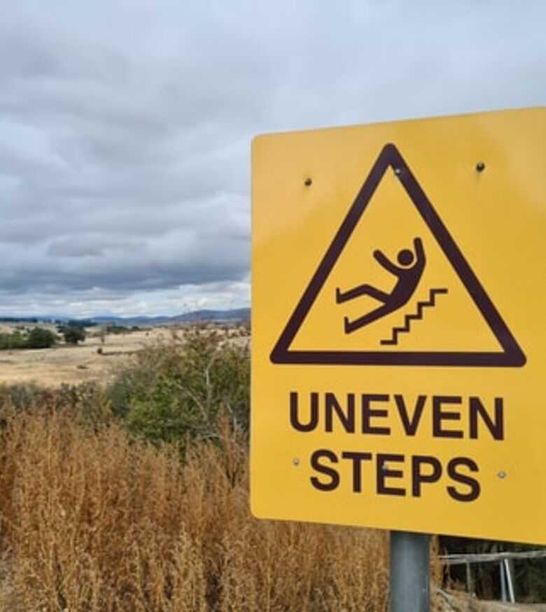 The Villages Slip and Fall Attorneys - uneven steps sign