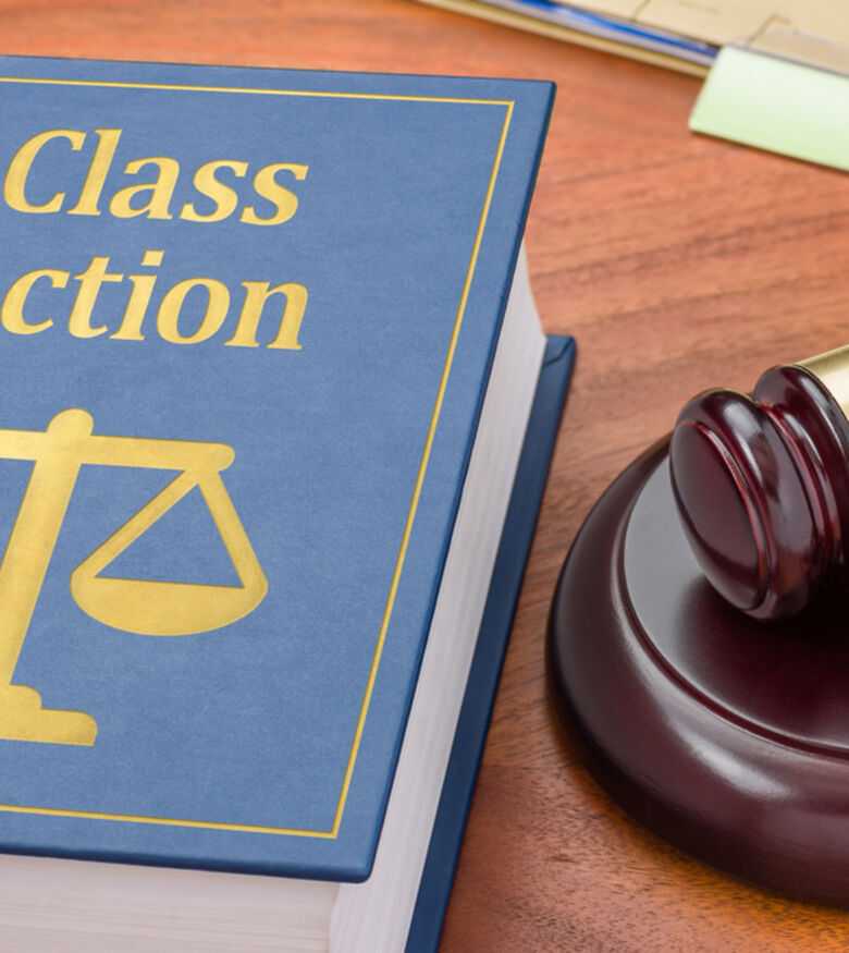 Class Action lawsuit book with scales of justice and gavel