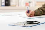 veteran filling out forms on desk