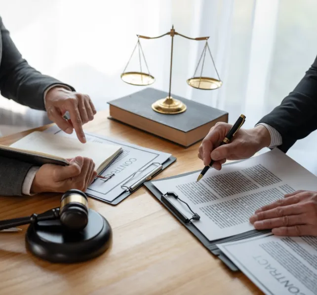 Lawyer, legal advisor, businessman brainstorming information on agreement details Business contracts in legal processing books for accuracy in contract documents. joint financial investment.