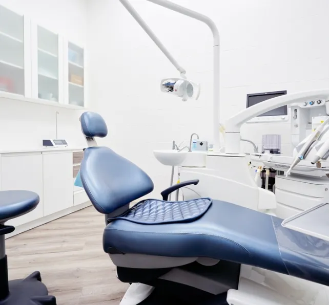 Dental equipment in dentist office in new modern stomatological clinic room. Background of dental chair and accessories used by dentists in blue and white.