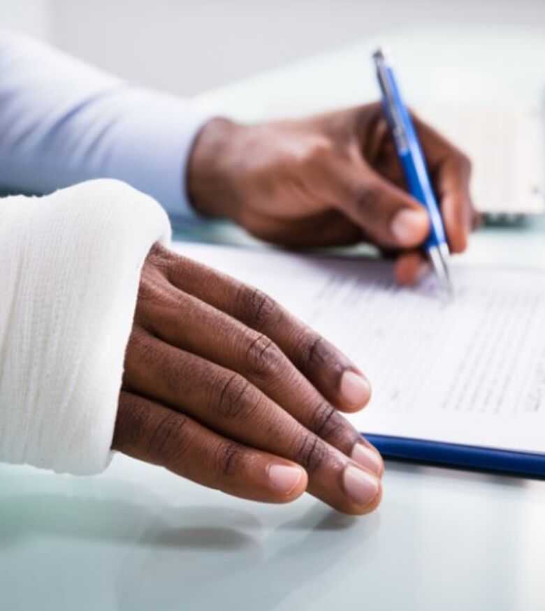 Gainesville, FL Insurance Claim Lawyers - Man with broken arm filling in an Insurance Claim Form 