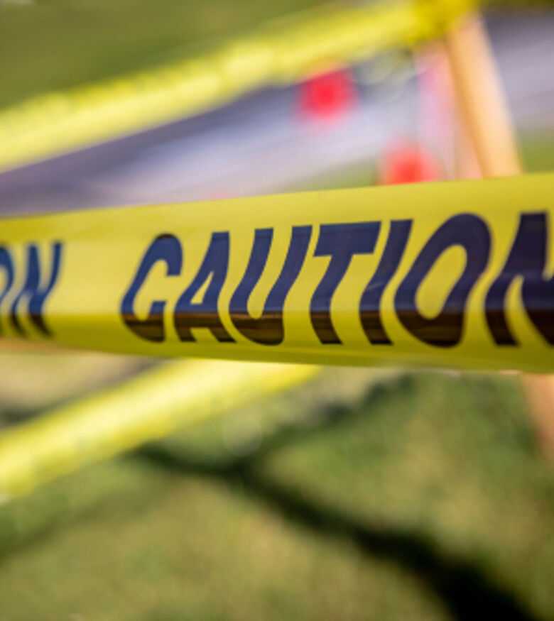 Caution tape at a crime scene represented by negligent security law firm