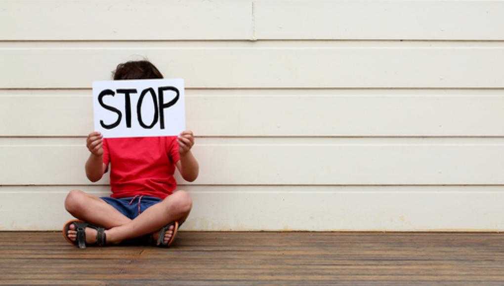 Florida Teen Combats Bullying With His Own Foundation - Kid Holding a Stop Bullying Sign