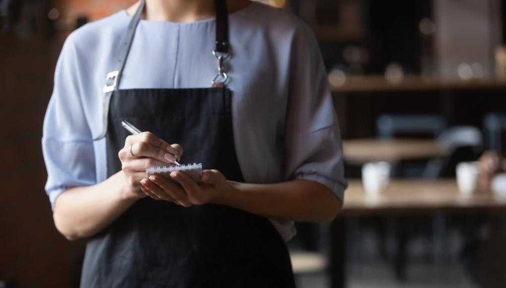 How Does Minimum Wage Apply to Tipped Employees - waitress taking order from table