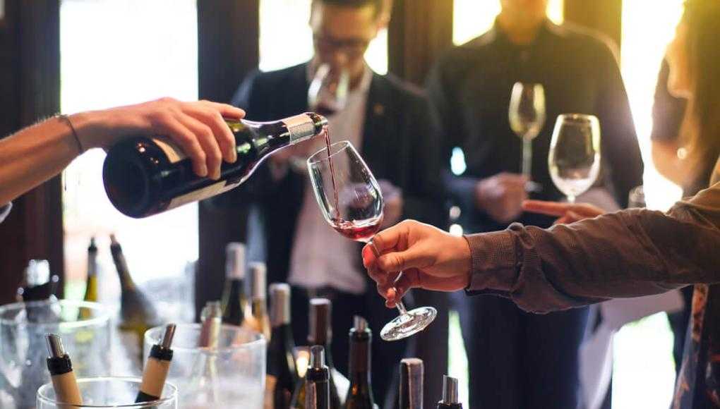 People enjoying wine tasting at a winery, demonstrating safe practices for responsible drinking and wine pouring.