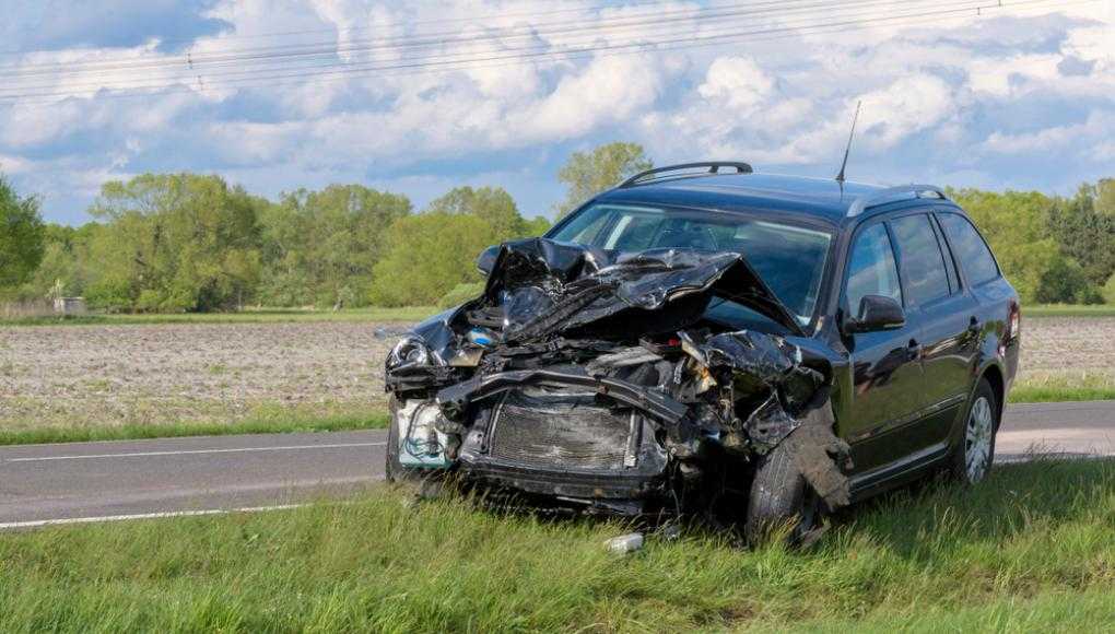 Totaled car on the side of the road