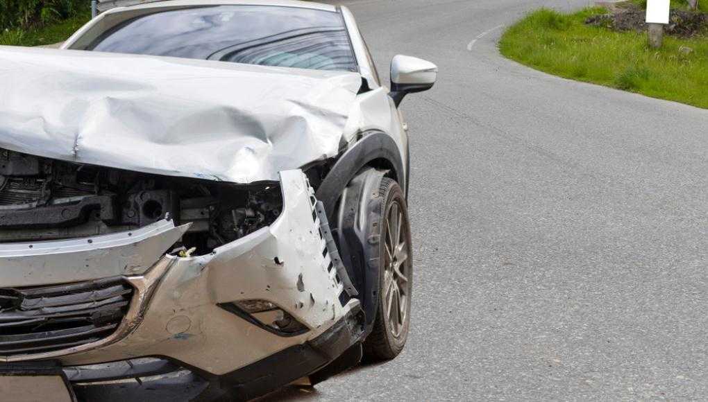 Damaged car on a curved road