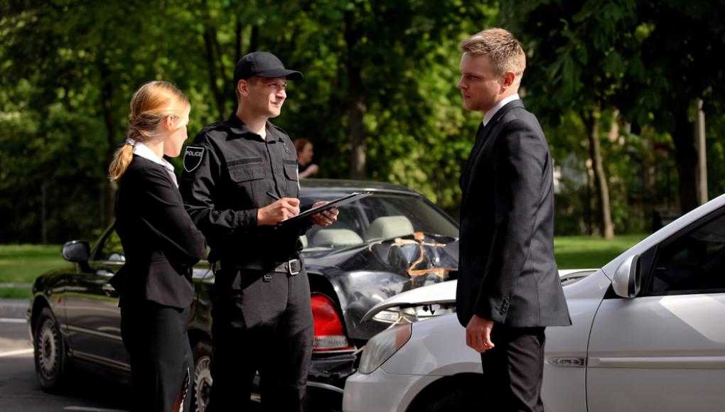 Policeman writing Police Report After an Accident