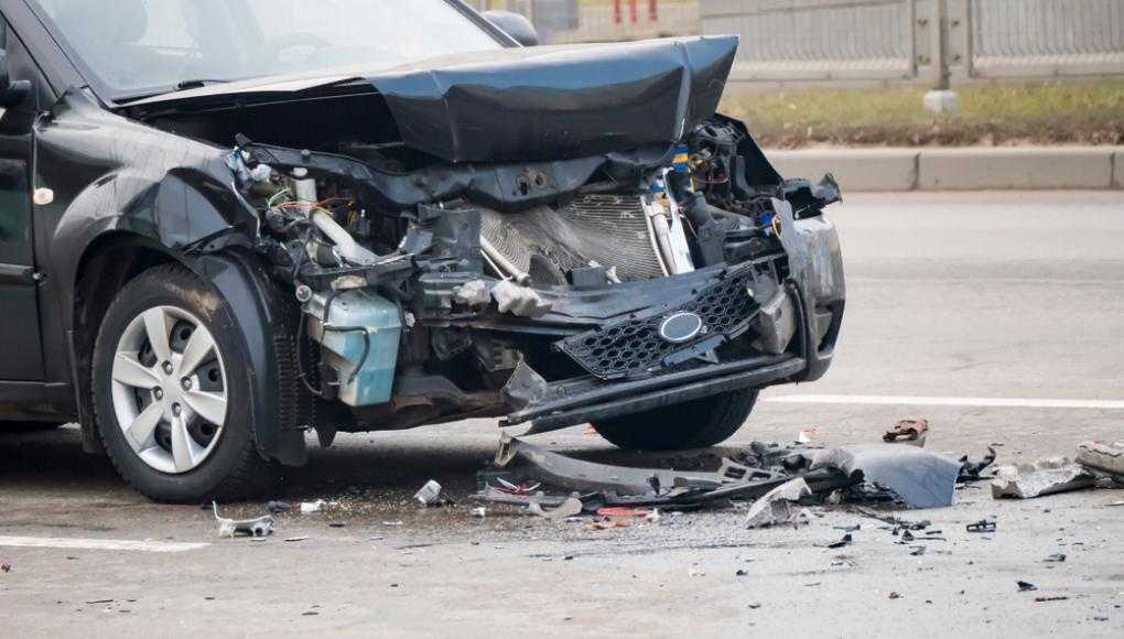 Severely damaged black car