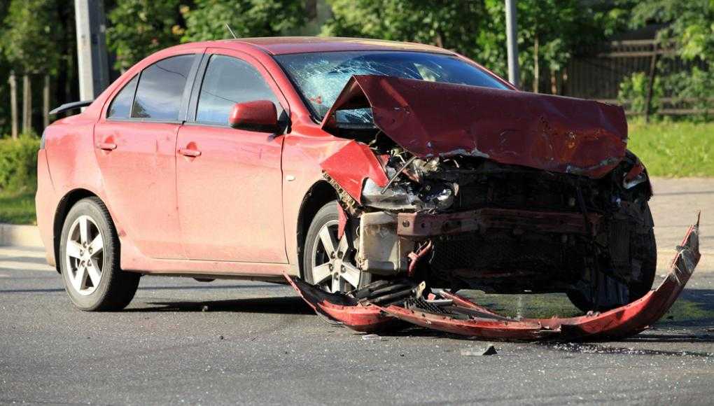 Red car with a damaged front bumper