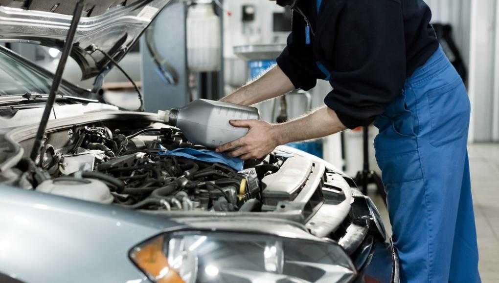 Mechanic servicing a car in an auto shop