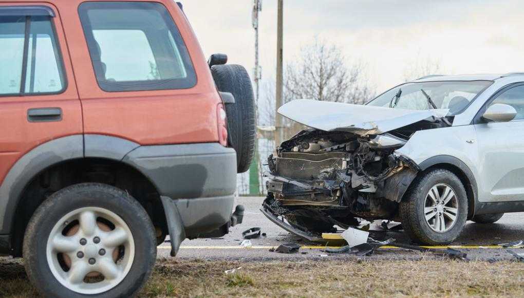 Grey car with severe front damage after an accident