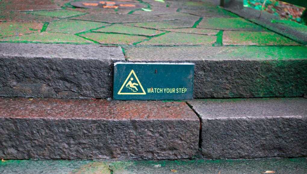 Watch your step sign on stairs