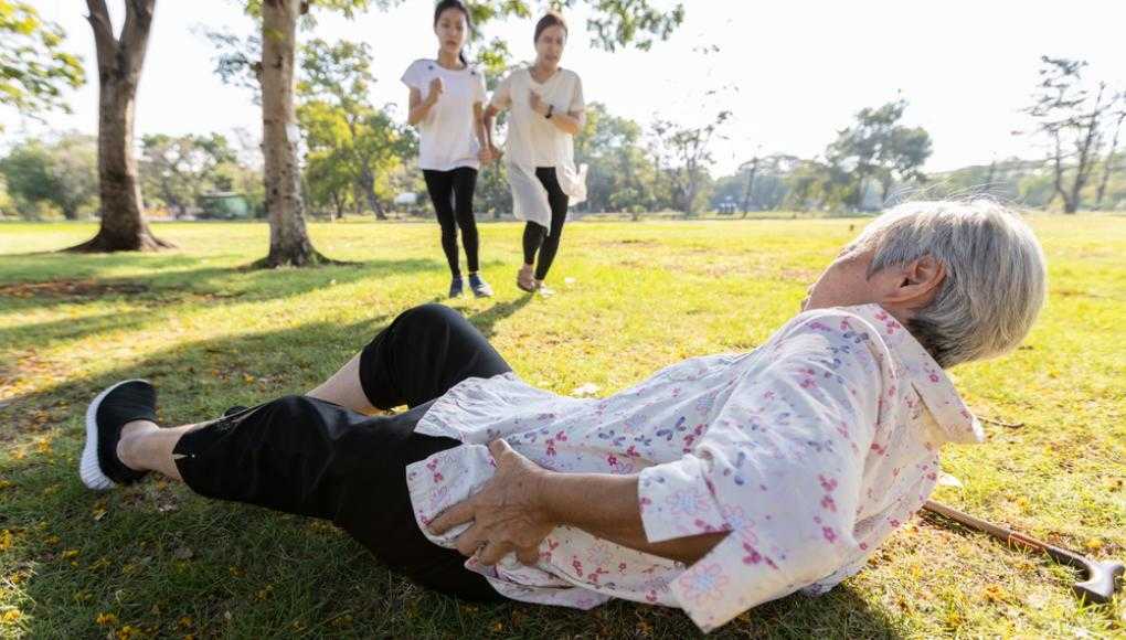 Elderly woman fallen down in a park