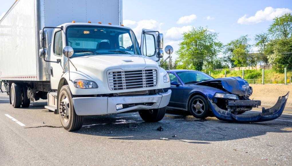 Damaged semi truck and car after an accident