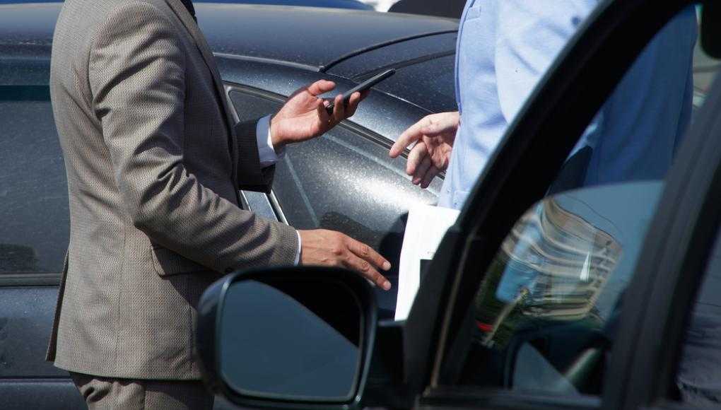 Two men discussing in a parking lot