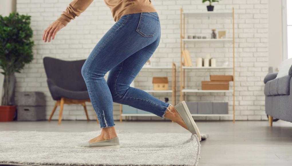 Woman tripping on a rug