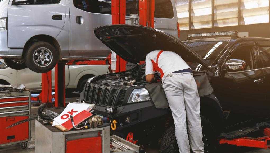 Mechanic working on a car at an auto shop