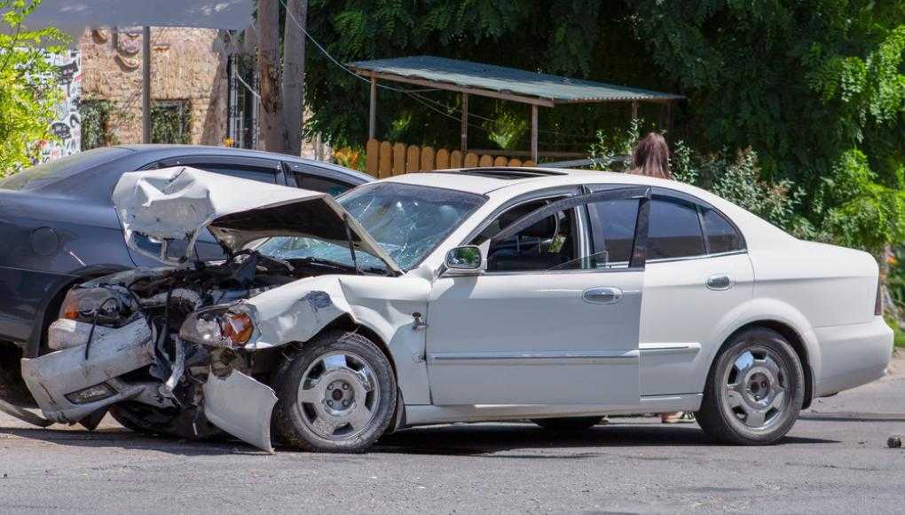 Damaged white car on the street