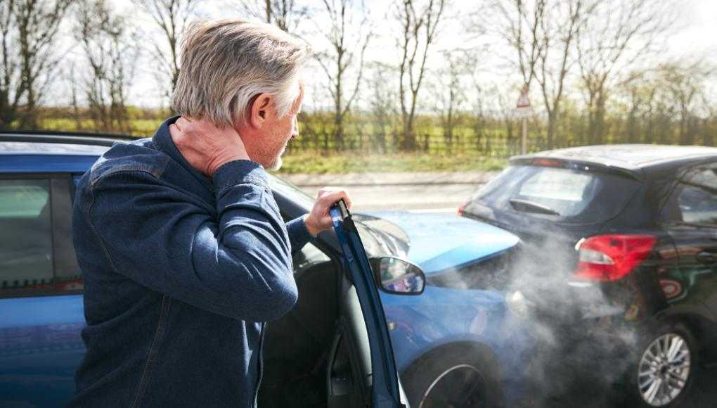 Man holding neck in pain after a car accident