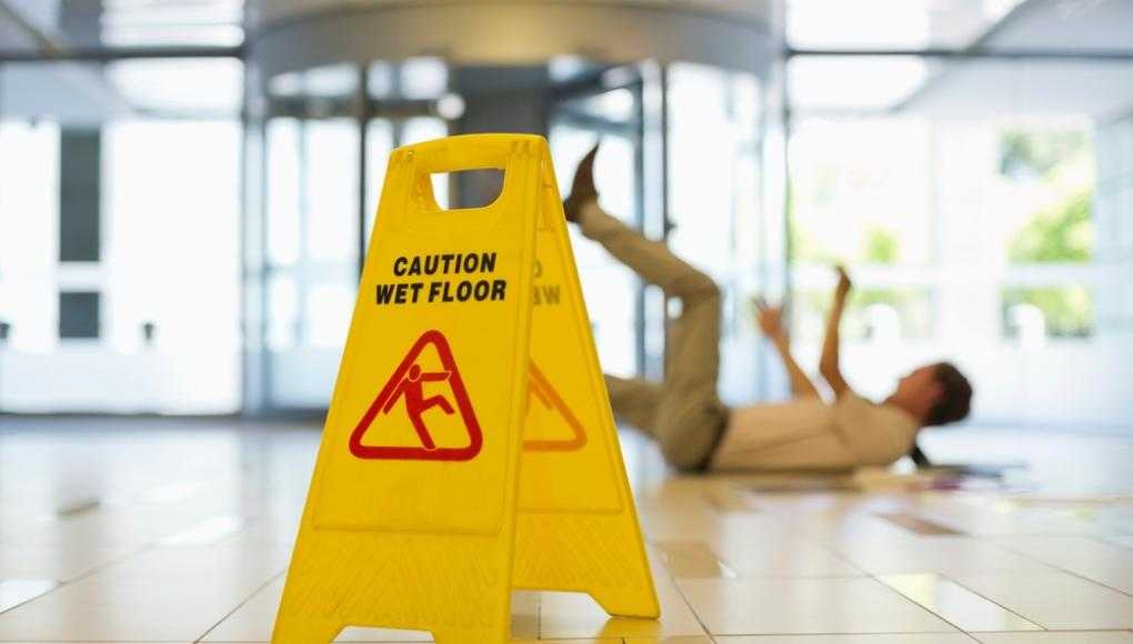 Caution wet floor sign and someone on the ground