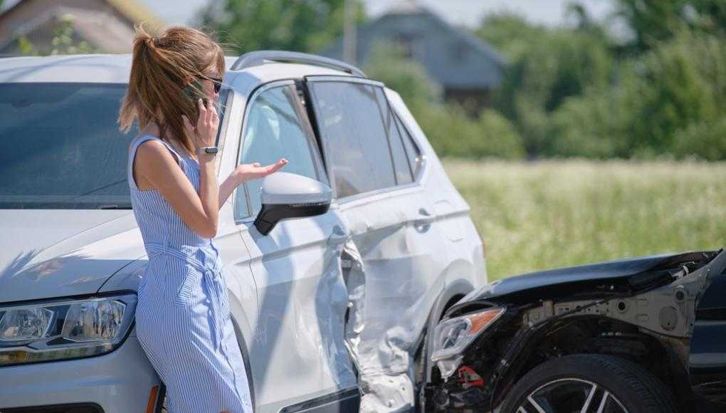 Woman on the phone after a car accident