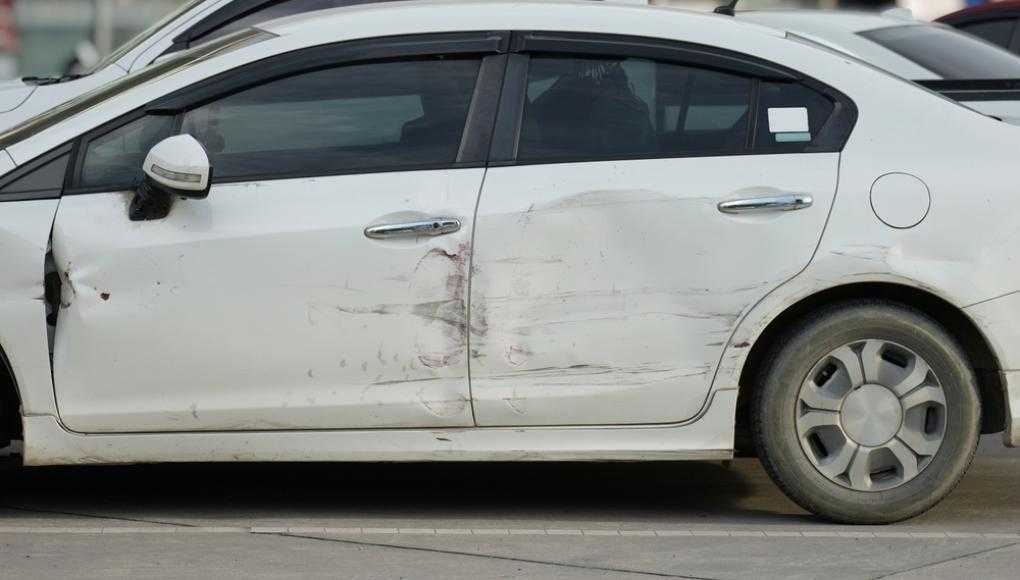 White car with a damaged door