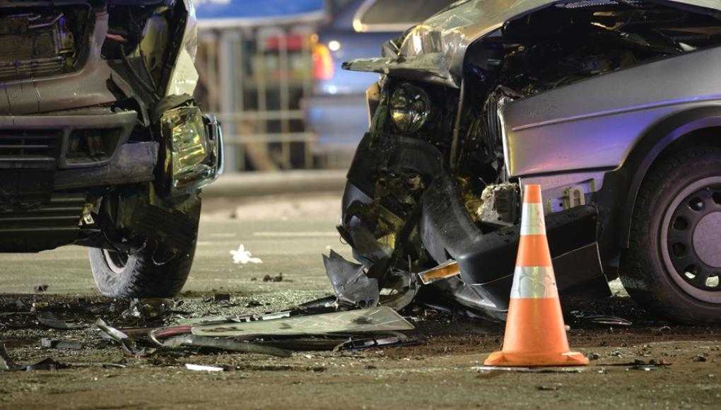 Two damaged cars after an accident with a cone