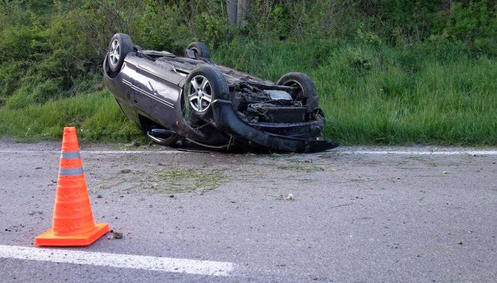 Car flipped upside down on the road