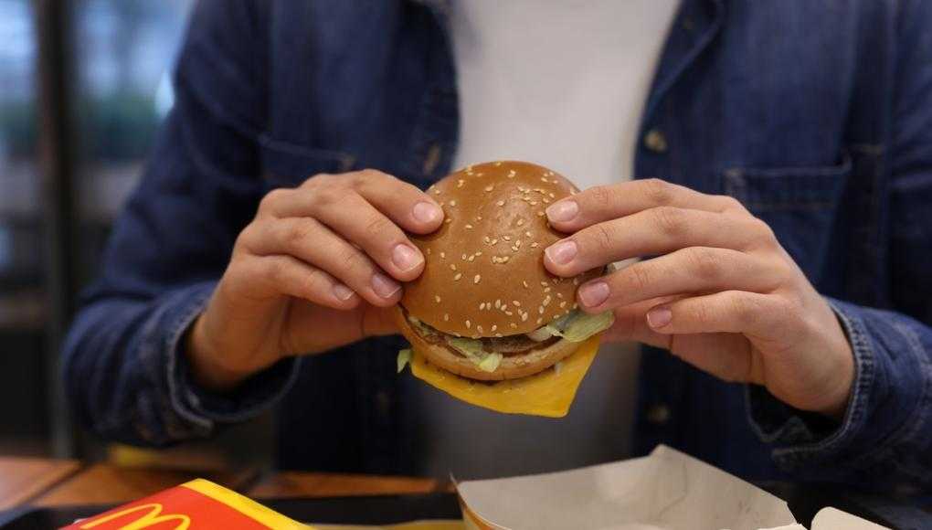 Someone eating a McDonald's burger