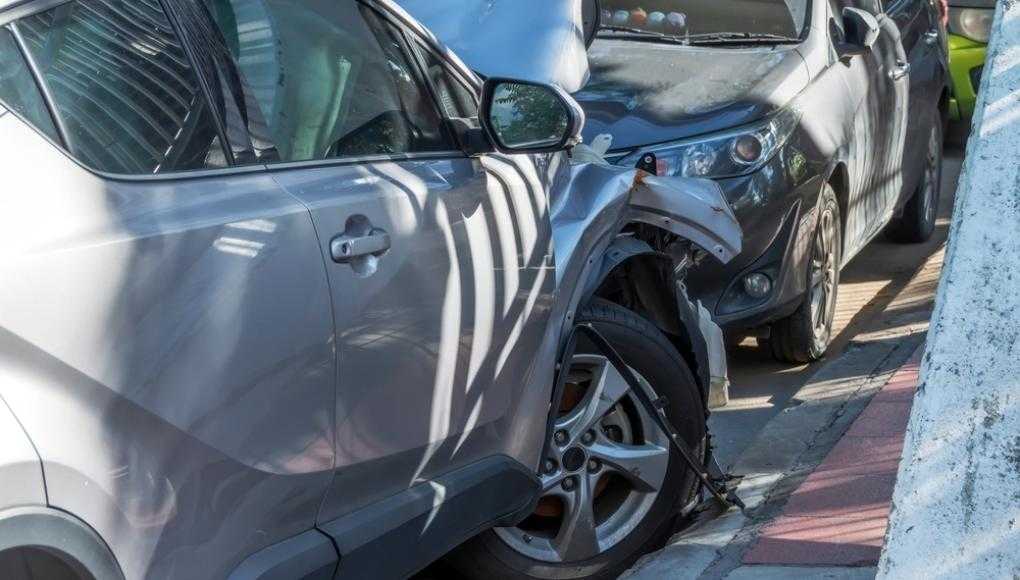 Grey car crashed into a parked car