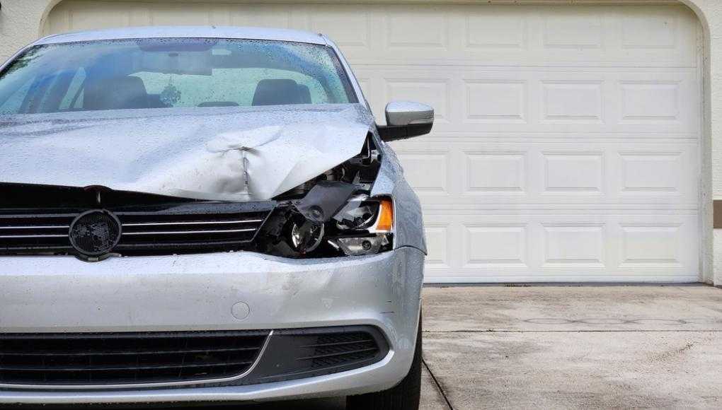 Damaged car in a driveway