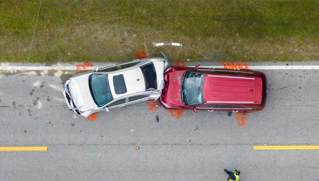 Arial view of a red car crashed into a grey car