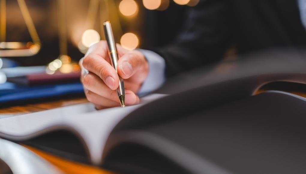 Businessman writing with a pen