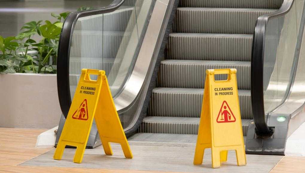 slip and fall sign at escalators