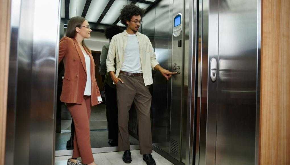 Two people getting into an elevator