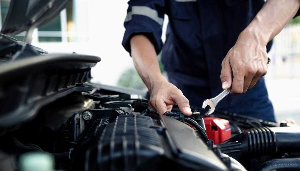 Mechanic fixing a part of a car