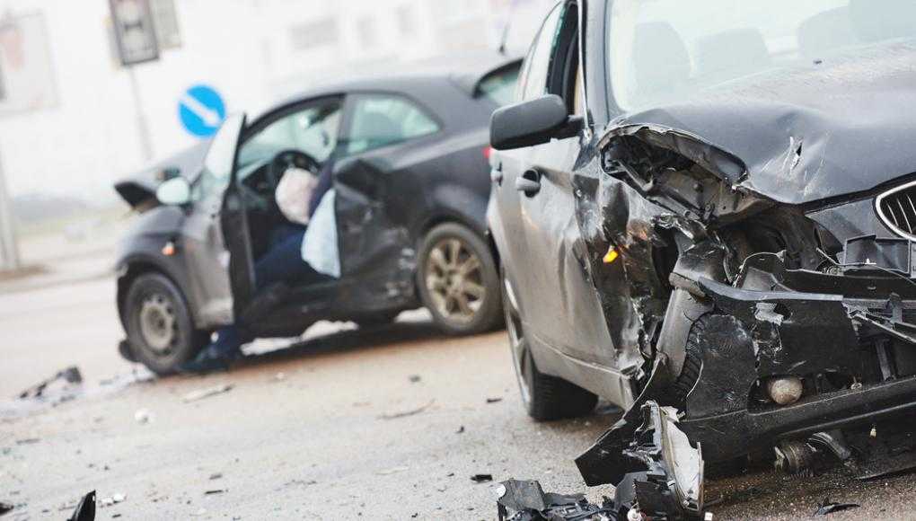 Two black cars with severe damage after an accident