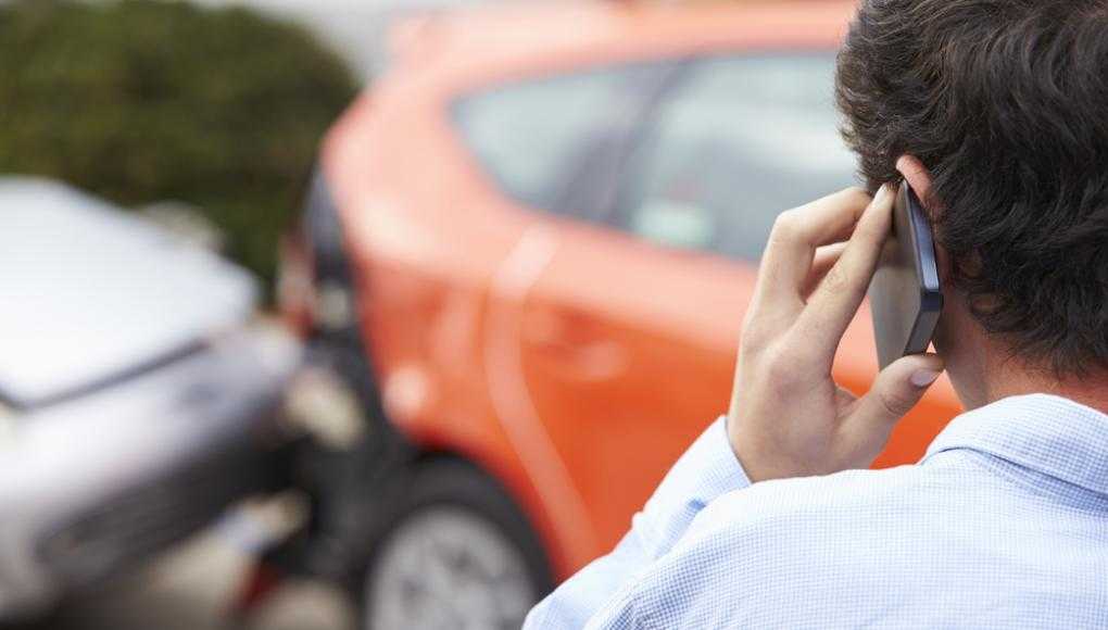 Man on the phone after a car crash