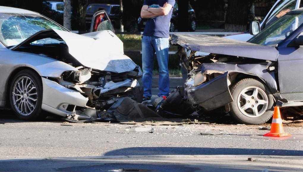 Man looking at two cars after an accident