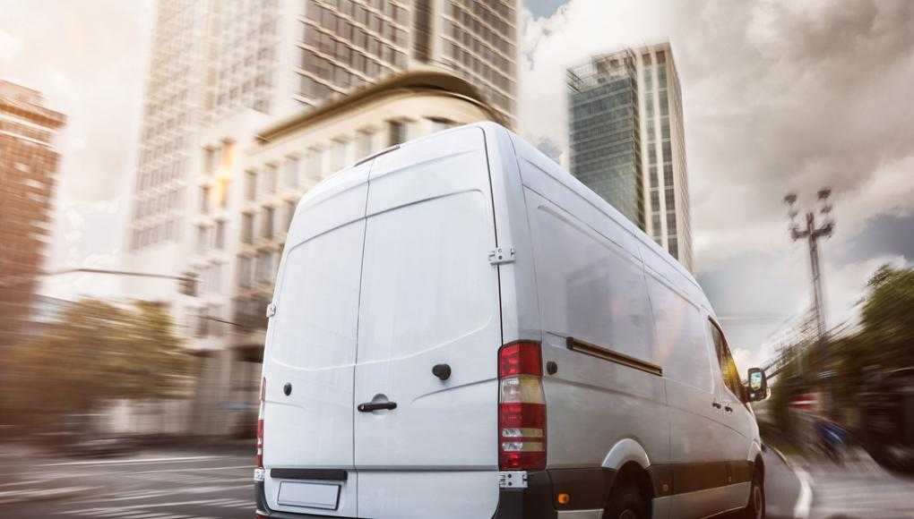 Van driving through a city