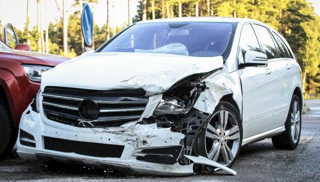 Damaged white car on the street