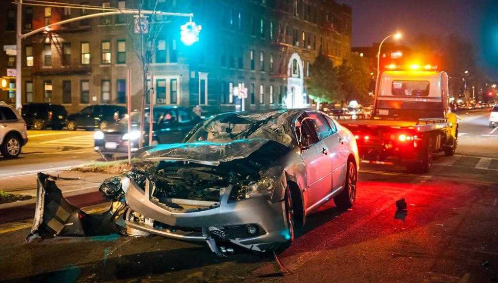 Damaged car getting towed after an accident on the street