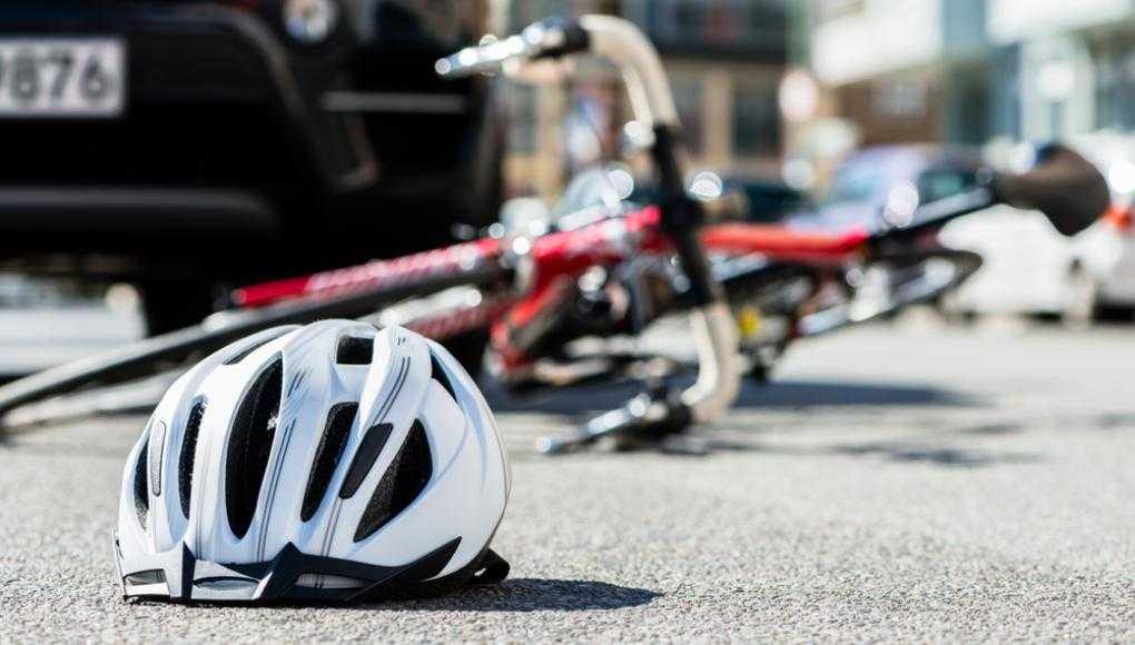 Bike helmet and bike fallen down on the road 