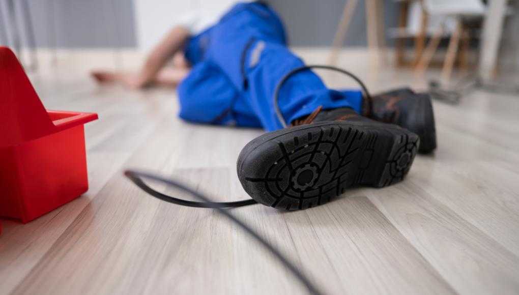 Man on the floor with his feet tangled in wire