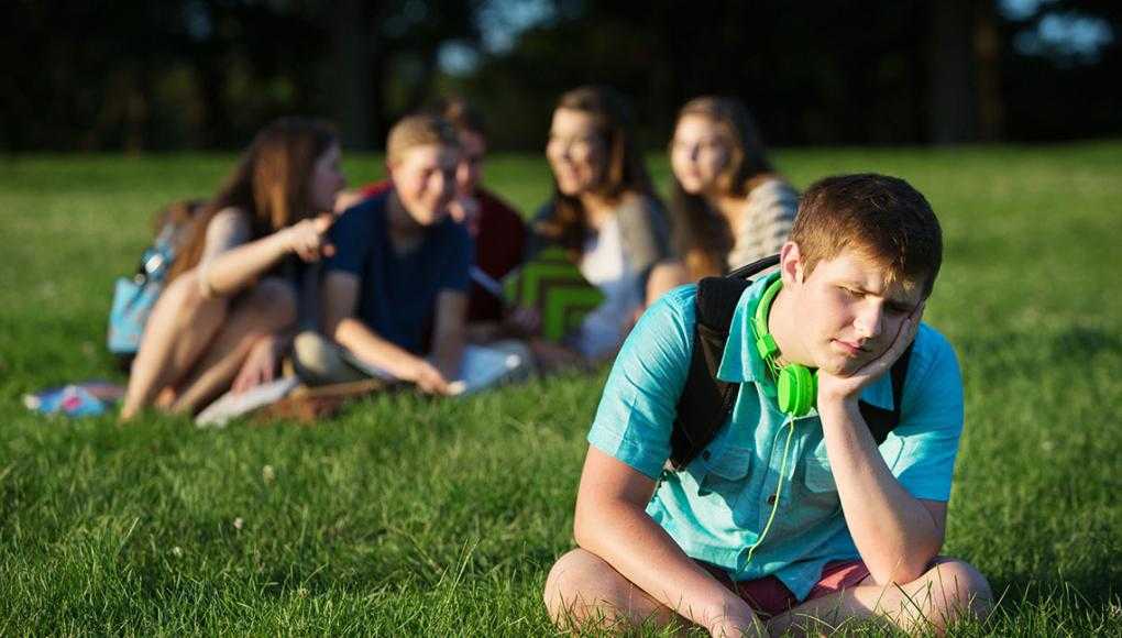 October is National Prevent Bullying Month - A group of students bullying a man.