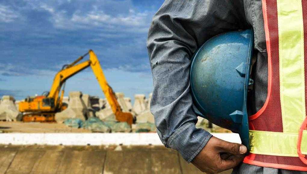 How Do Construction Accidents Happen? - workers holding his hard hat