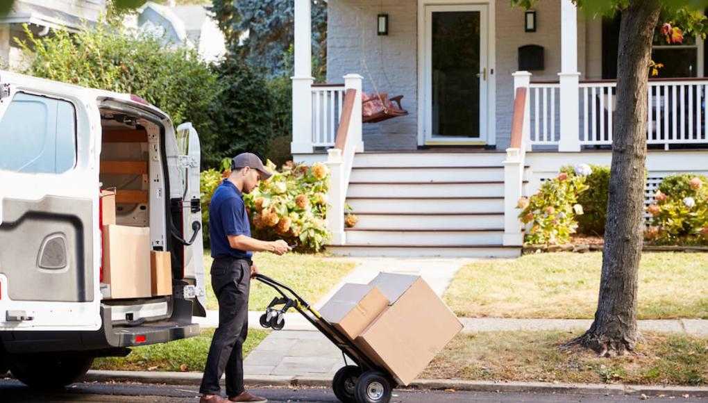 courier delivery driver on curb with packages